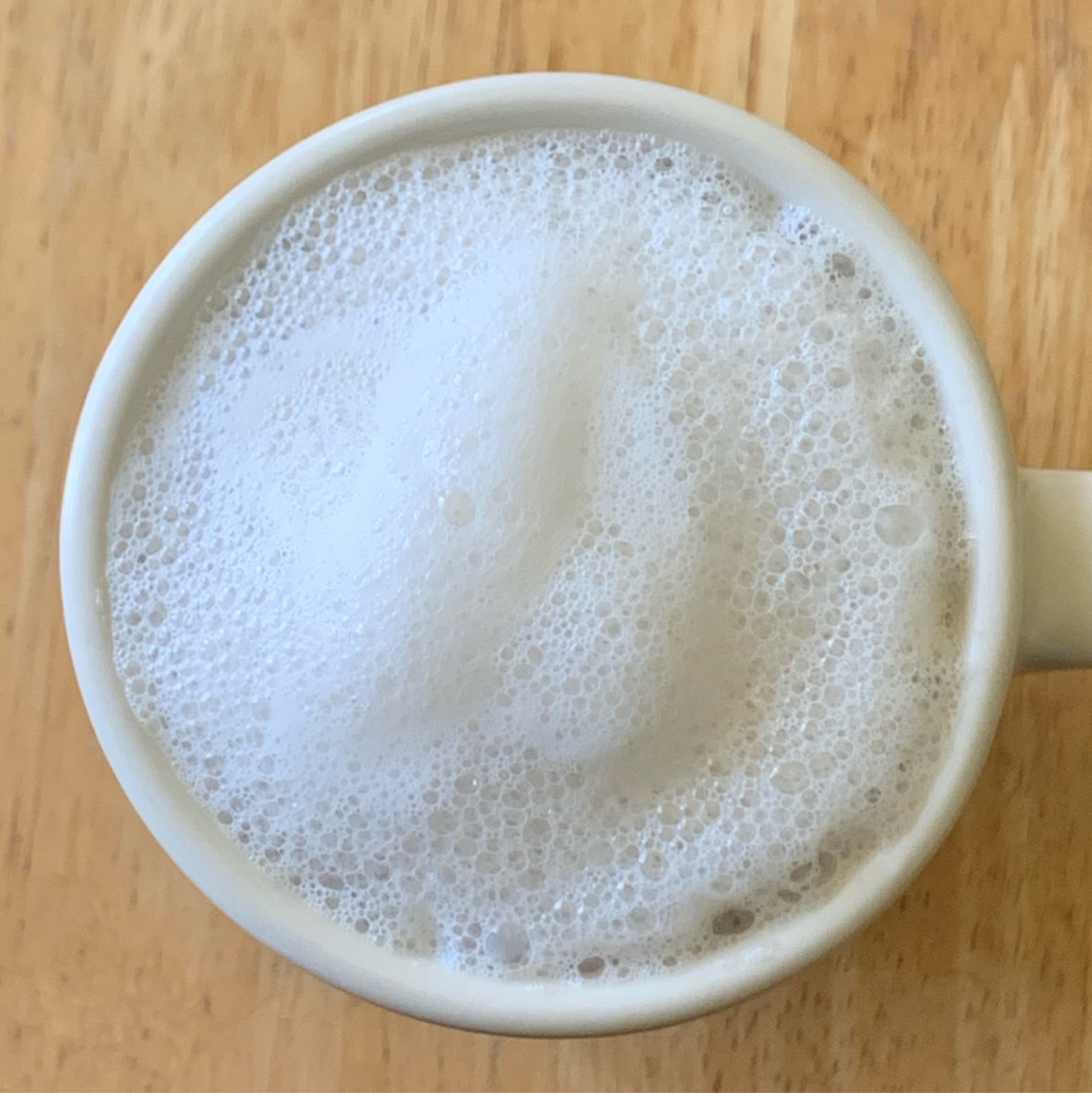top down view of frothed milk foam in a cup