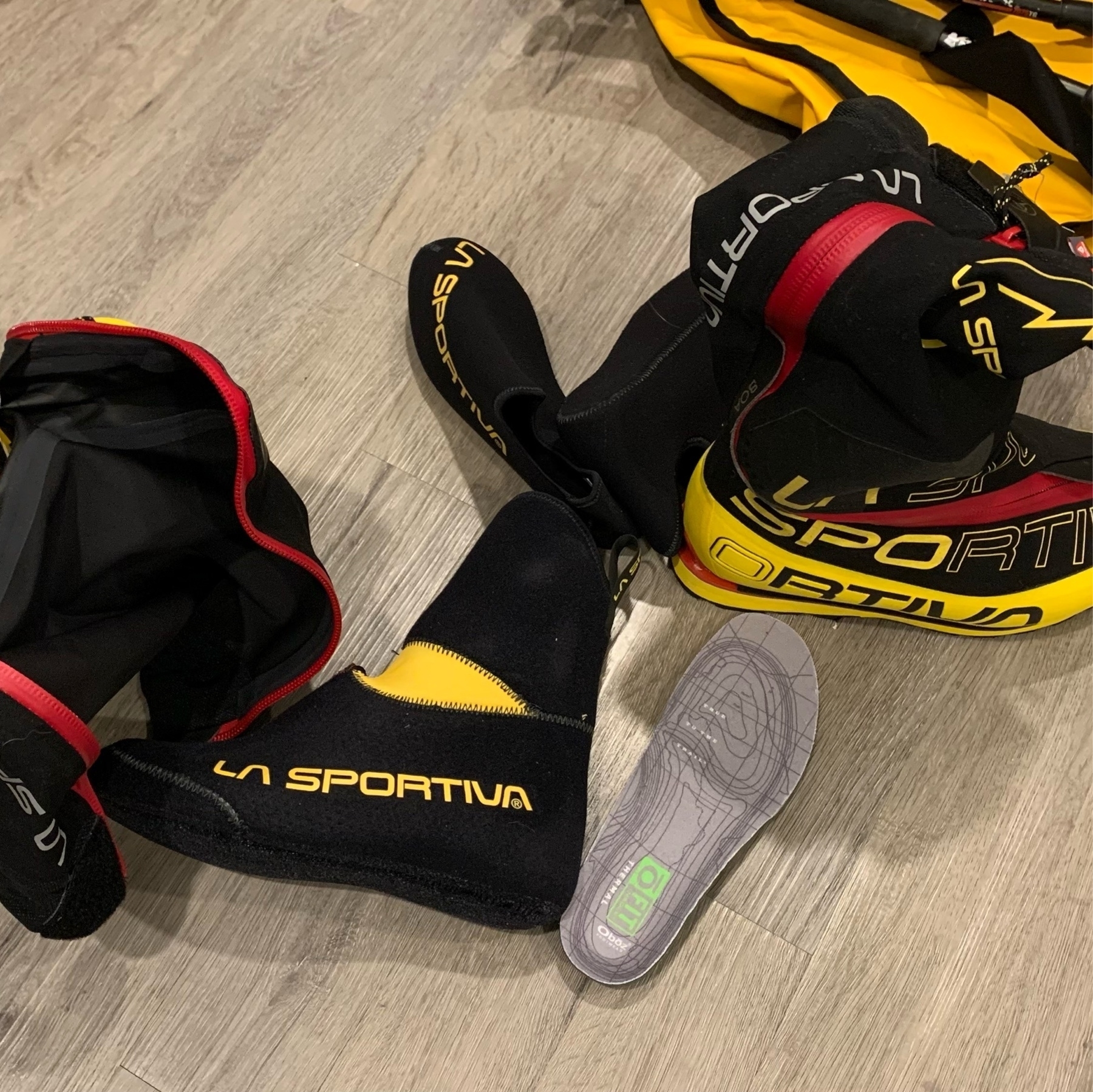 mountaineering triple boots on the floor in a state of disarray