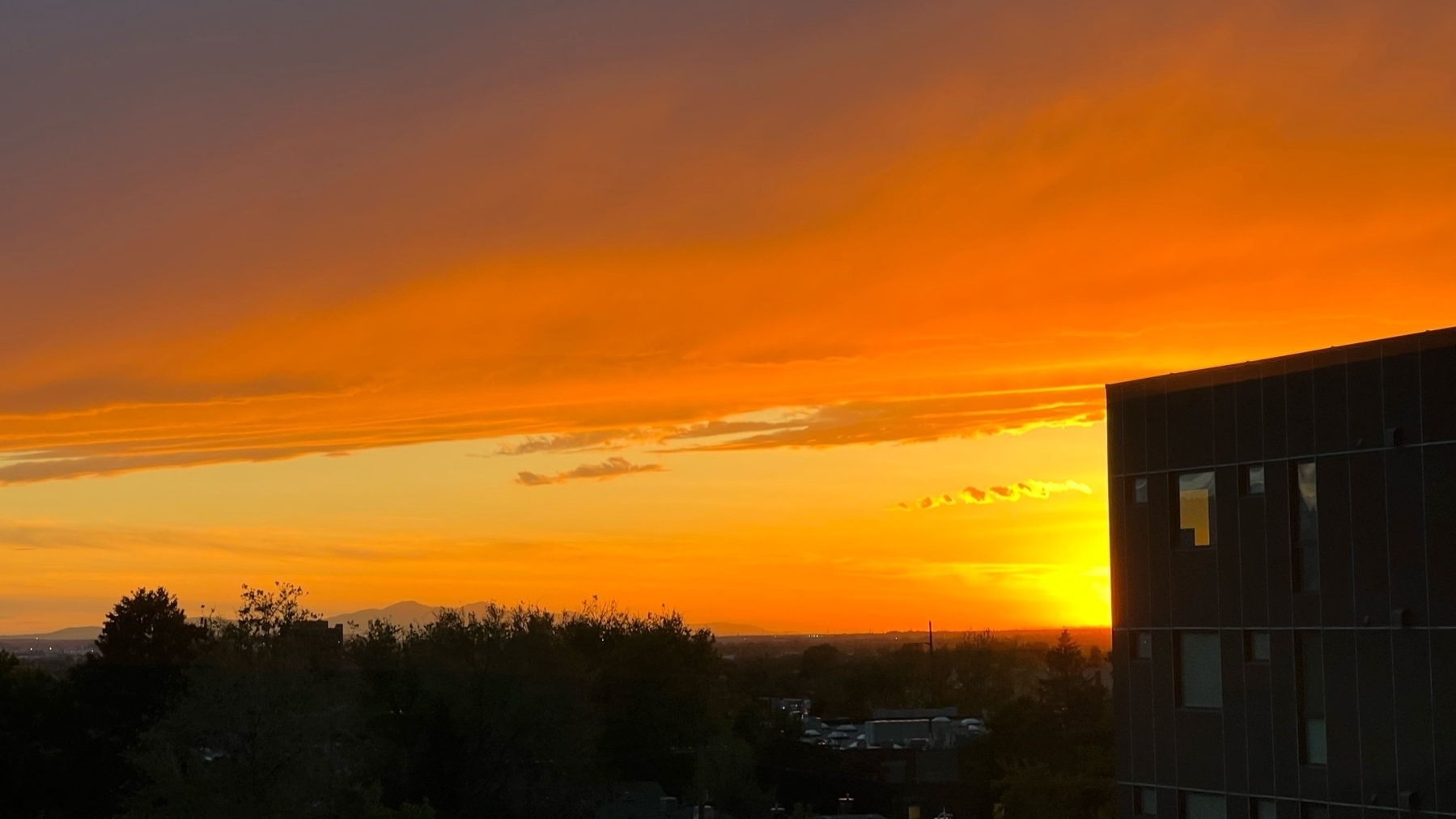 cityscape sunset with vibrant oranges and yellows